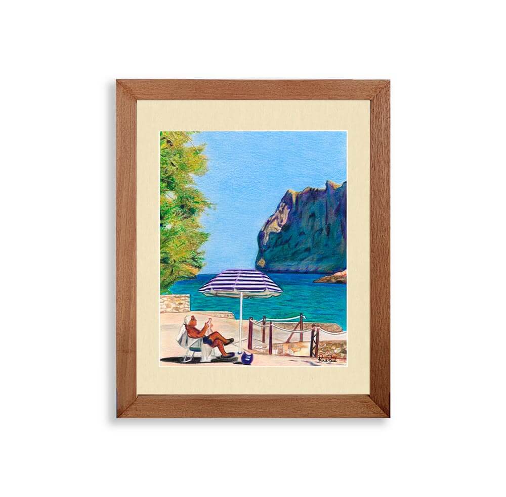 Renee Reid wood framed art print a man sitting by the beach under an umbrella reading the newspaper