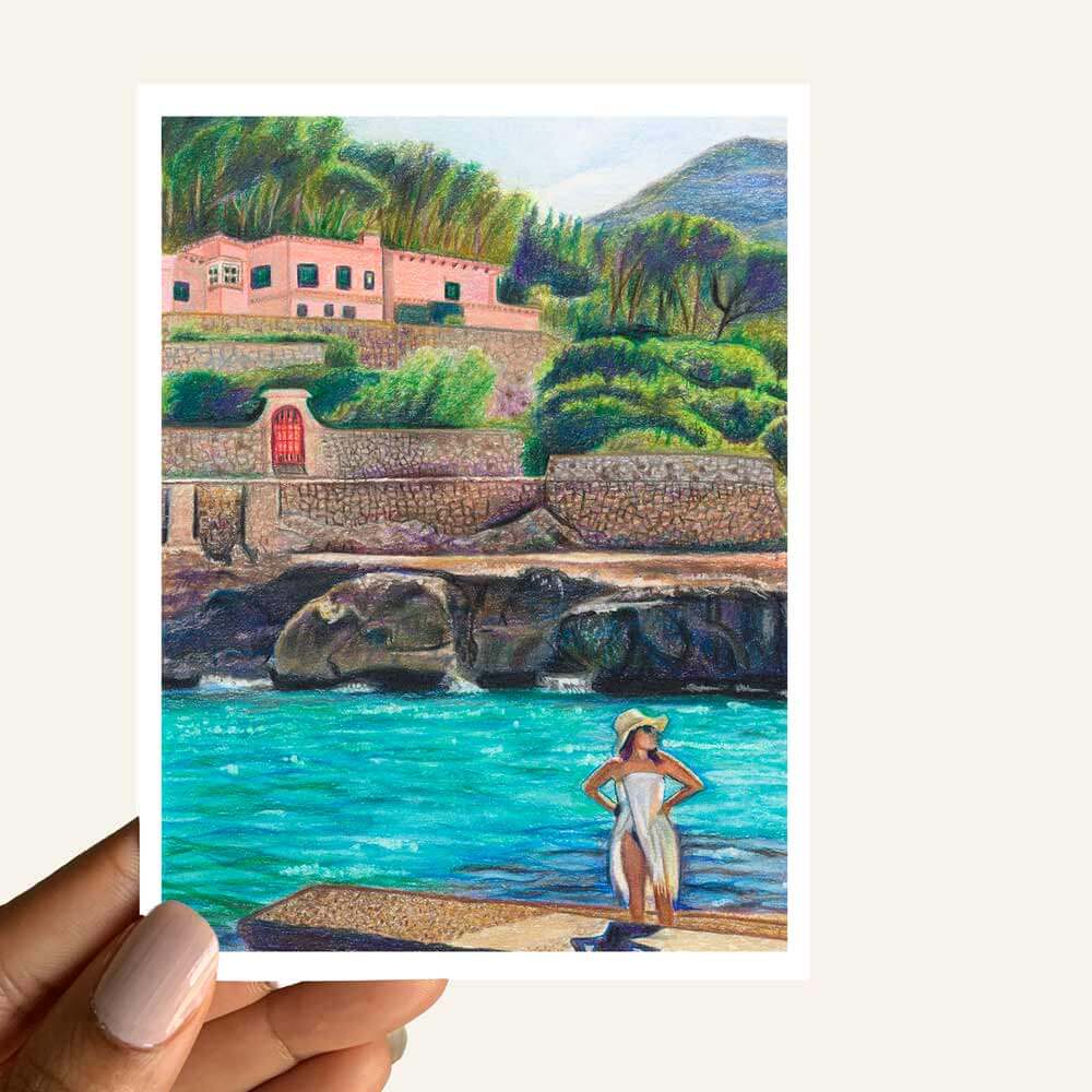 Close up of greeting card of a woman on a beachside landing glazing into the distance