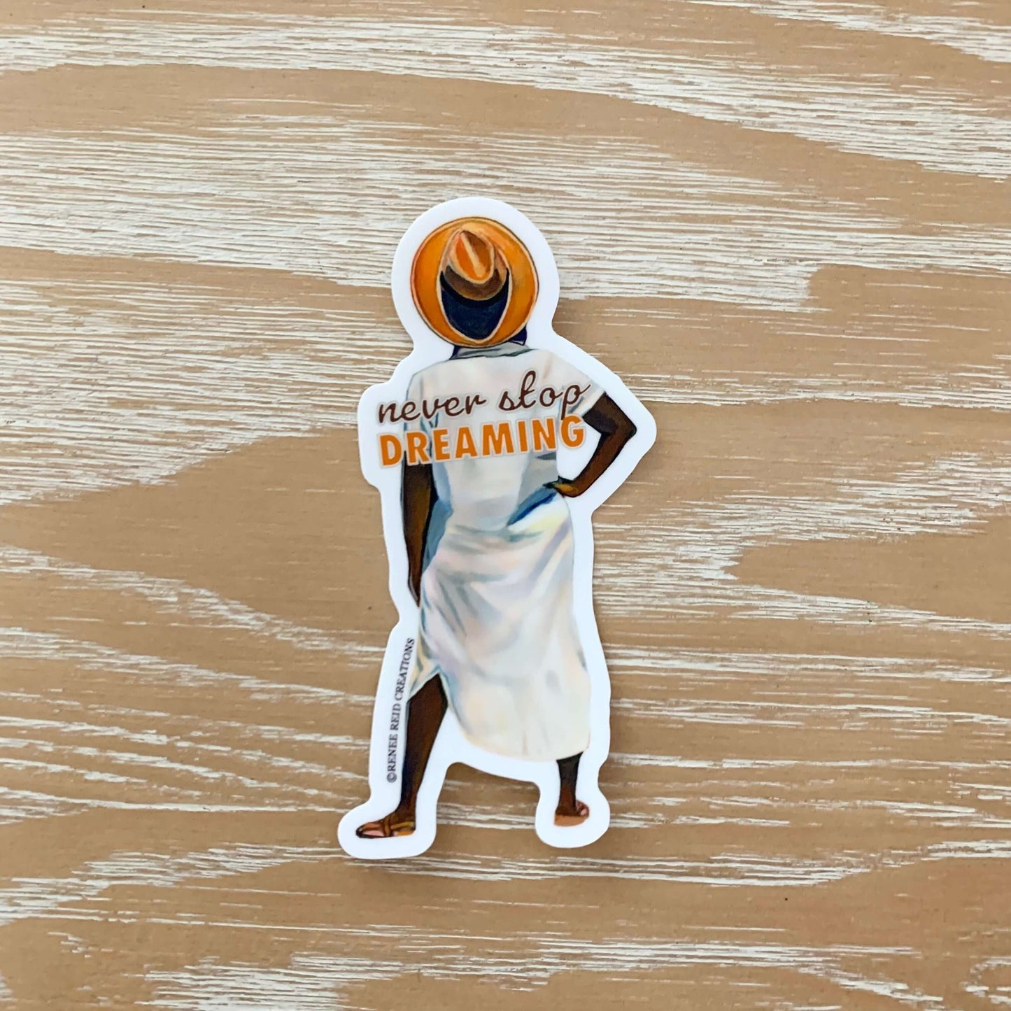 Vinyl sticker of a woman from Renee Reid's Original Artwork Dreamy with the saying "Never Stop Dreaming"