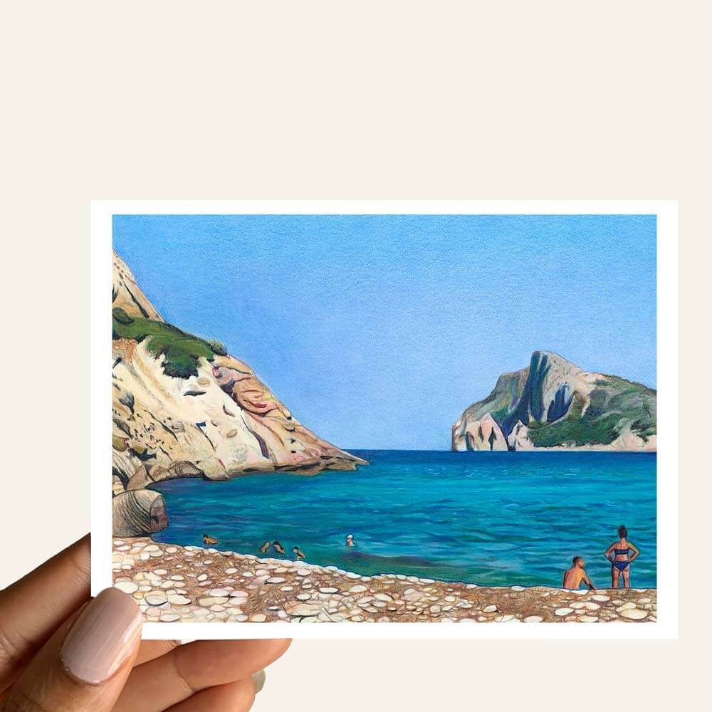 Close up of greeting card of a beach scene with a woman, a man, rocky beach, blue sky and cliffs