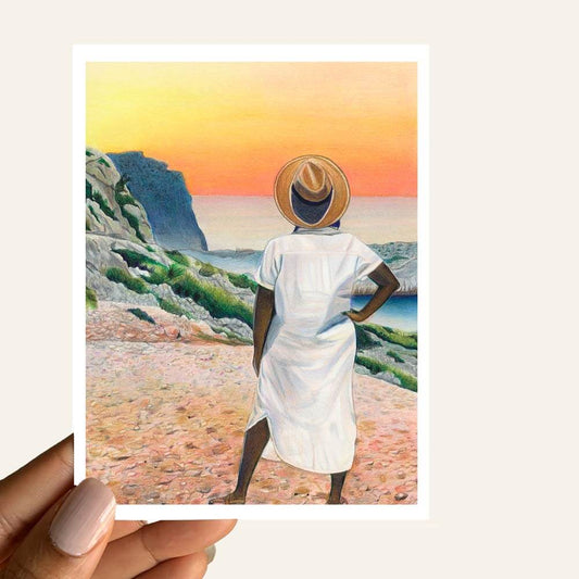 Sunkissed Horizon Greeting Card showing a figure in a white dress overlooking a vibrant sunset by mountains and ocean.