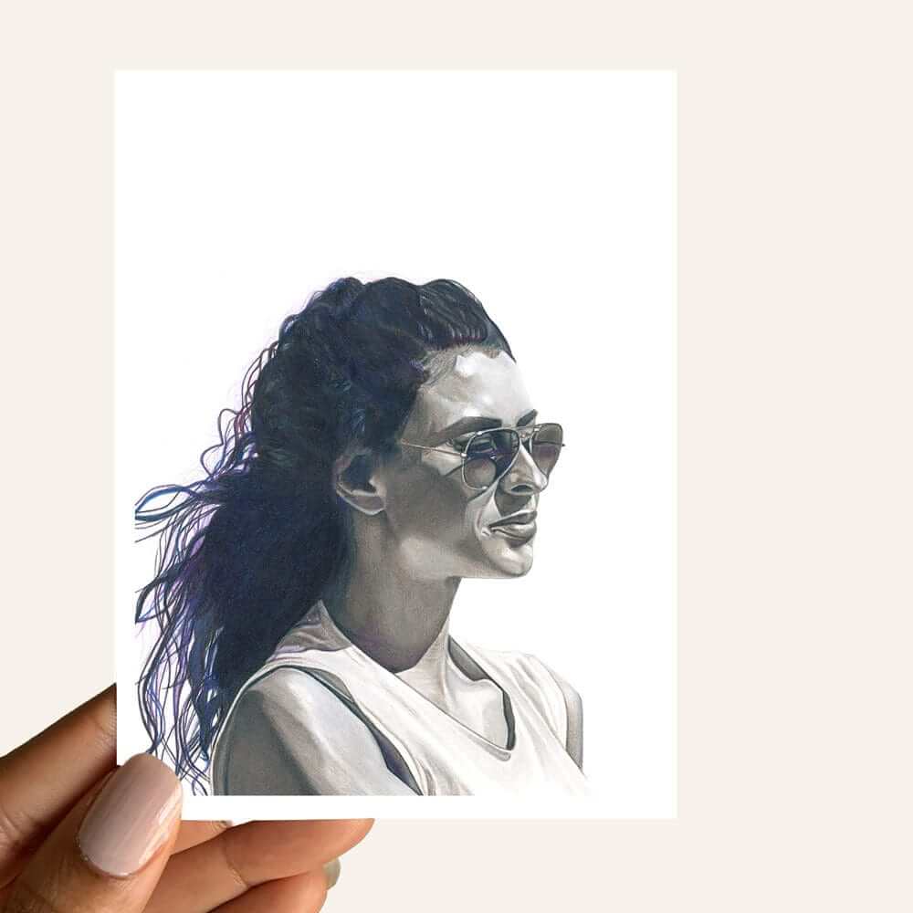 Close up of greeting card of a monochromatic woman with a pensive look wearing sunglasses peering into the distance