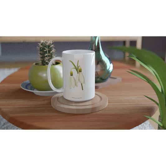 Snowdrop Duo Flower Mug showcasing delicate blooms on a wooden coaster, creating a serene table setting.