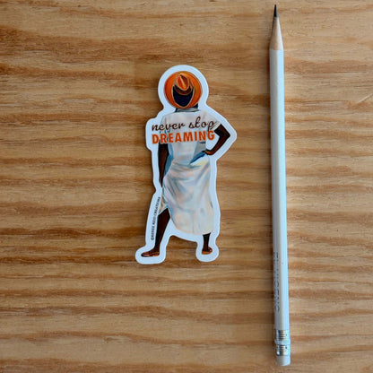 Beyond the Horizon Vinyl Sticker with 'never stop dreaming' text on a wooden surface with a pencil for scale.