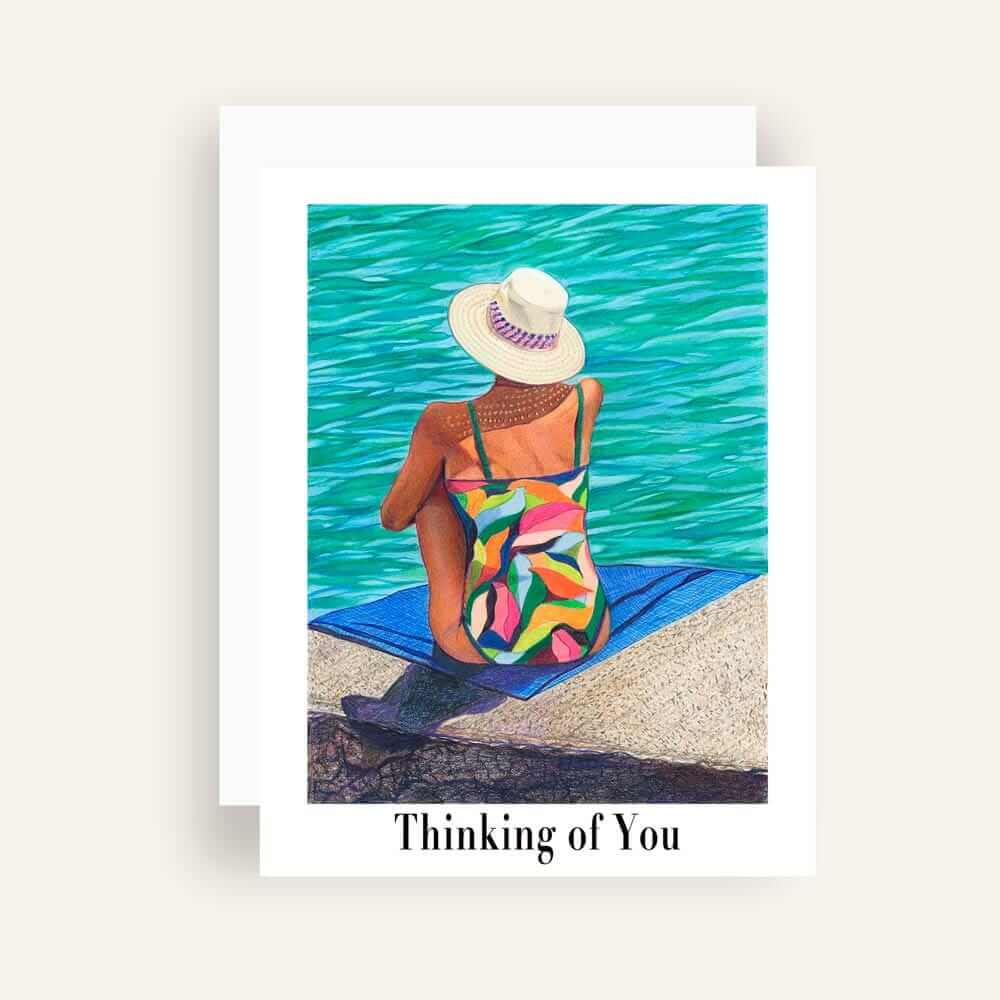 Close up of greeting card with generic text and art of a woman in a colorful swimsuit daydream on a seaside landing