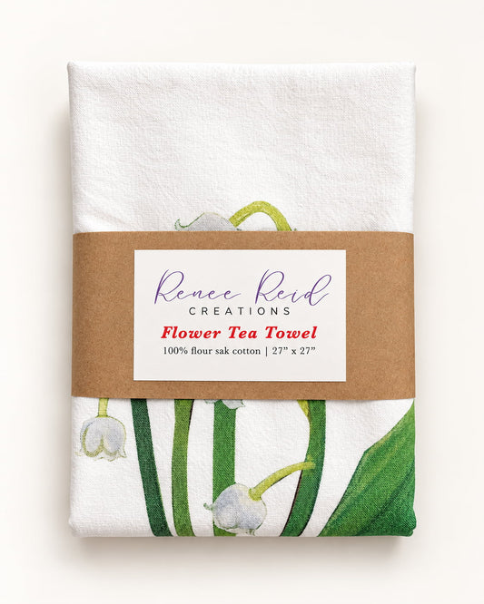 Lily of the Valley Floral Cotton Tea Towel wrapped, featuring Renee Reid's floral artwork on 100% flour sack cotton.