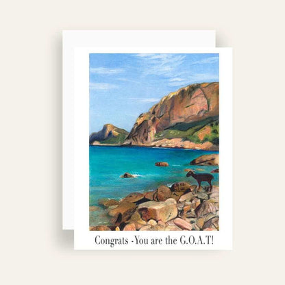 Close up of greeting card with generic text and art of a goat on a rocky seaside beach with cliffs in the background 