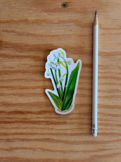 Lily of the Valley Flower Vinyl Sticker next to a pencil on a wooden surface