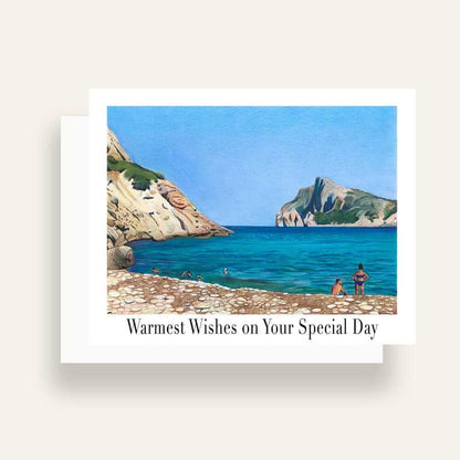 Close up of greeting card with generic text and art of a beach scene with a woman, a man, rocky beach, blue sky and cliffs 