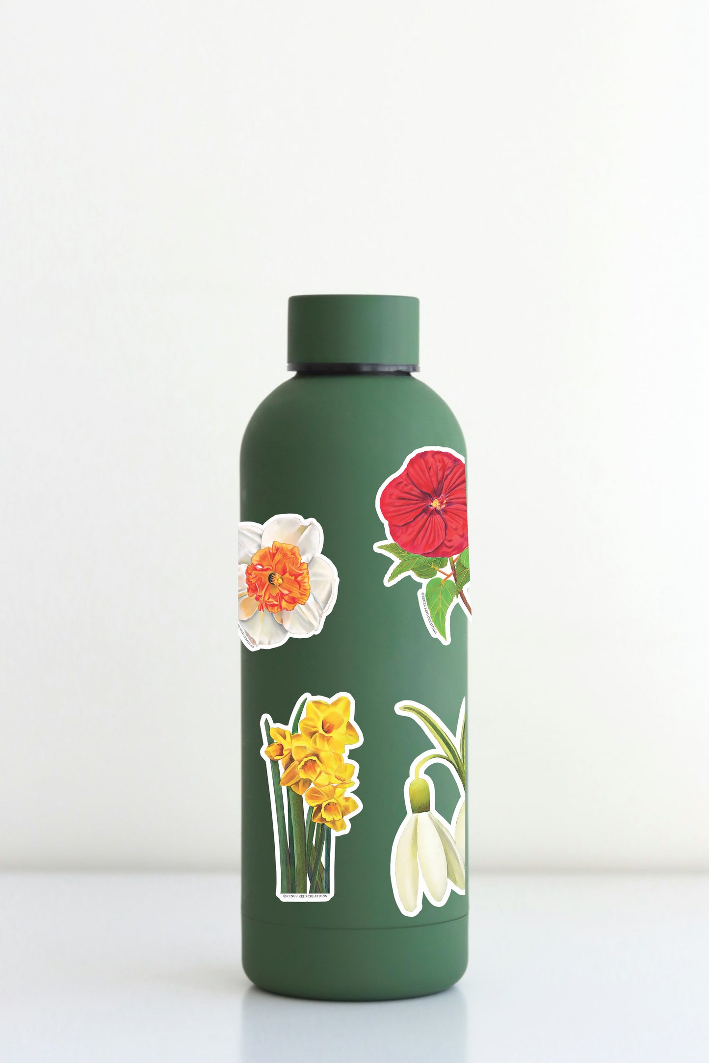 Xtra-Large Flower Sticker Sheet on a green water bottle with floral designs like Snowdrop and Red Poppy.