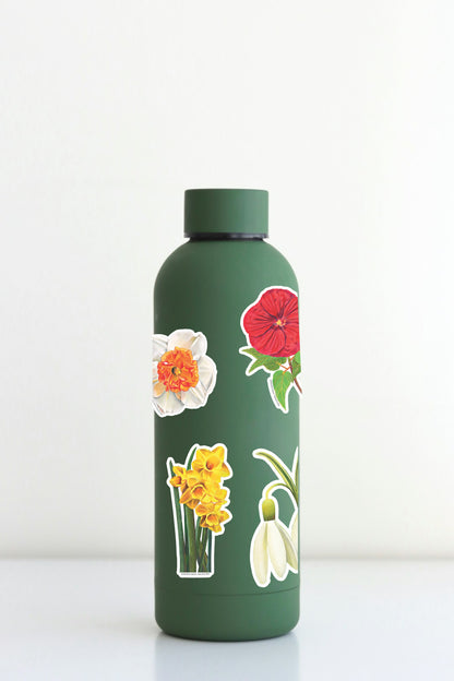 Xtra-Large Flower Sticker Sheet on a green water bottle with floral designs like Snowdrop and Red Poppy.