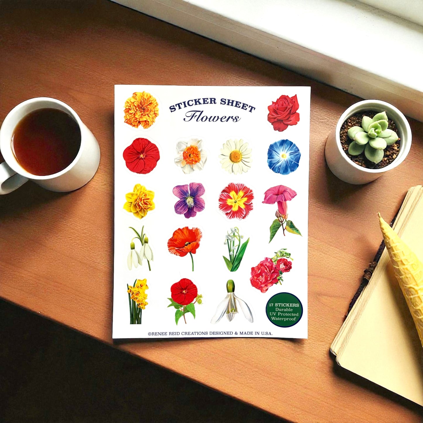 Xtra-Large Flower Sticker Sheet featuring various colorful flower designs on a wooden table with coffee and plants.