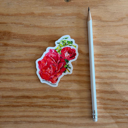 Pink Rose with Leaves Flower on a wooden surface next to a white pencil.