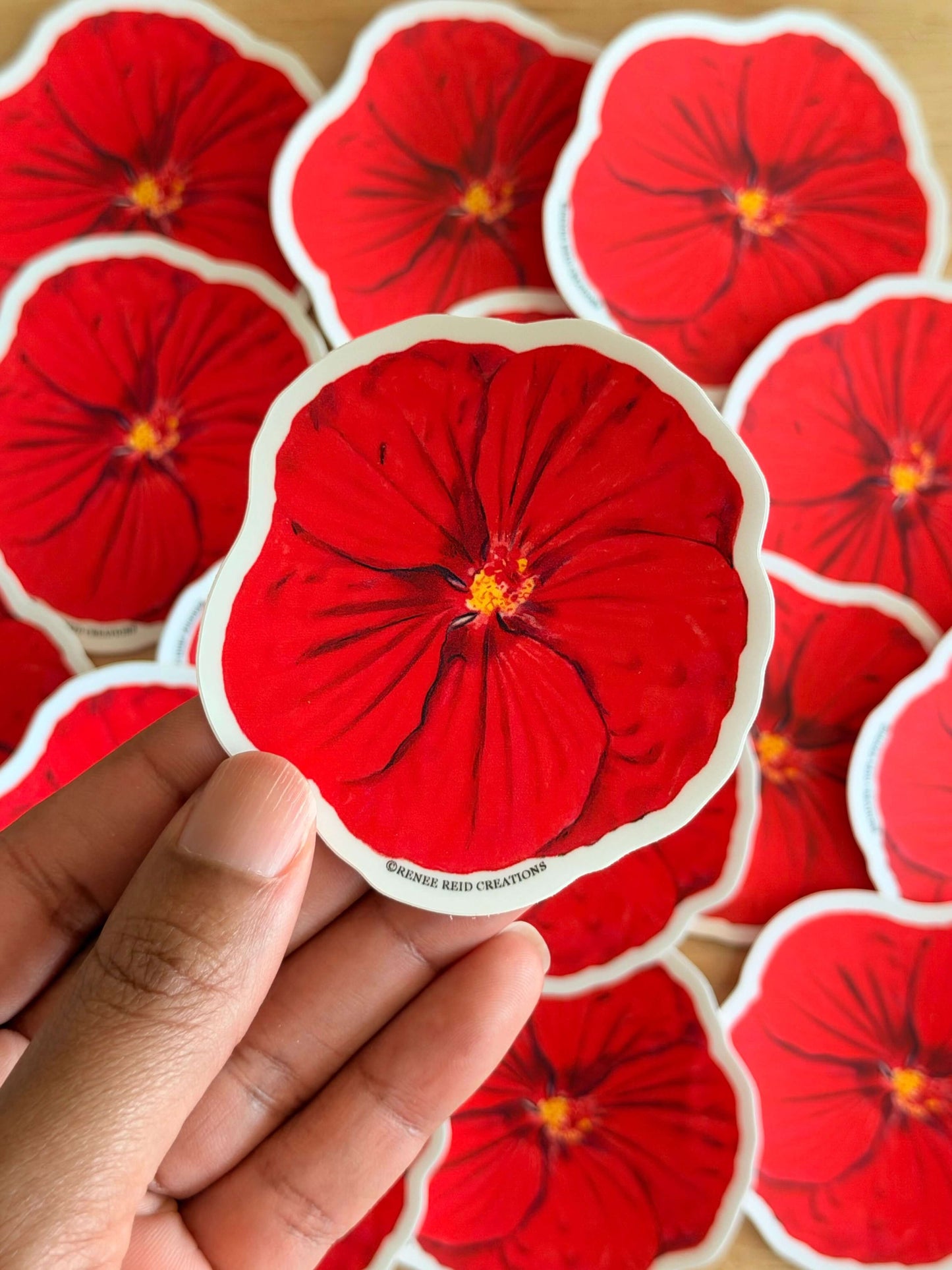 Red Hibiscus Flower Stickers with a hand holding one of them.