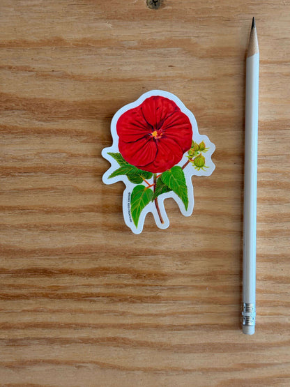 Red Hibiscus Flower Sticker on a wooden surface with a pencil