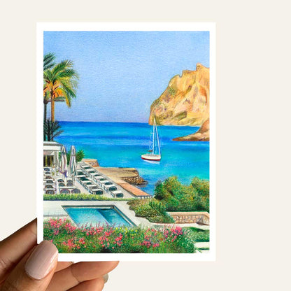 Close up of greeting card of a view of an ocean resort with cliffs, beach, boats and palm trees 