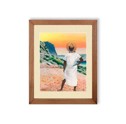 Renee Reid framed art print of a woman gazing into the horizon at a colorful sunset 