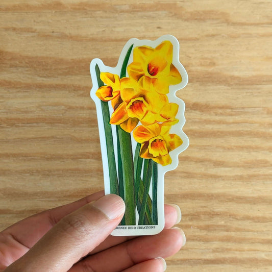 Hand holding a Yellow Daffodil with Leaves Flower Vinyl Stickeron a wooden surface