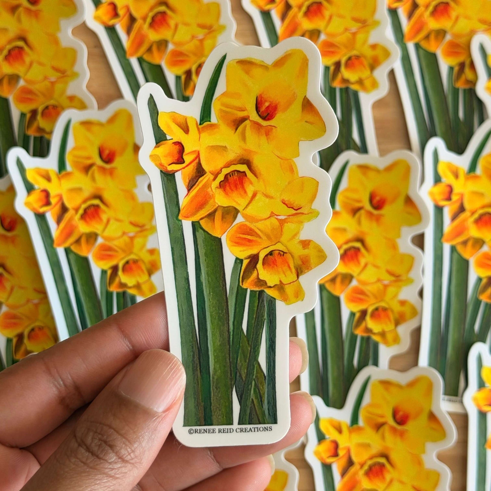 Yellow Daffodil with Leaves Flower Vinyl Sticker design against a background of similar stickers.