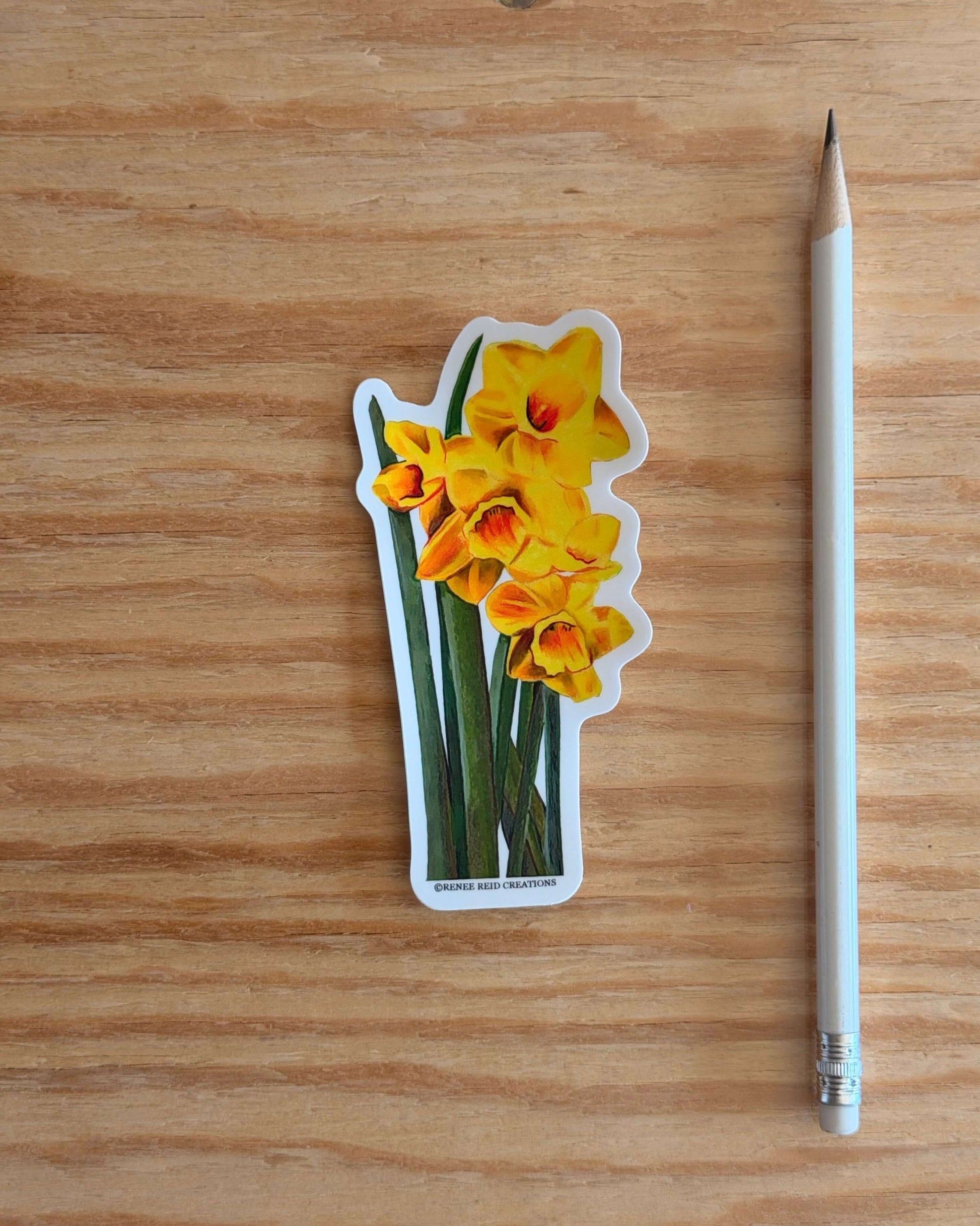 Yellow Daffodil with Leaves Flower Vinyl Sticker with a pencil on a wooden surface