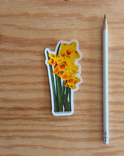 Yellow Daffodil with Leaves Flower Vinyl Sticker with a pencil on a wooden surface